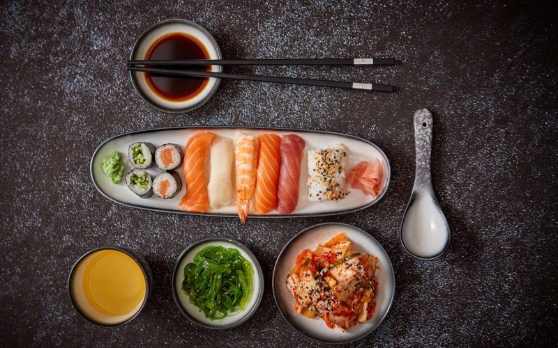 asian-food-assortment-various-sushi-rolls-placed-ceramic-plates-kimchi-goma-wakame-salads-soy-souce-chopsticks-sides-grungy-dark-background-with-copy-space (2)