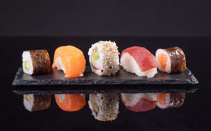 assorted-sushi-served-slate-plate-dark-background-japanese-food