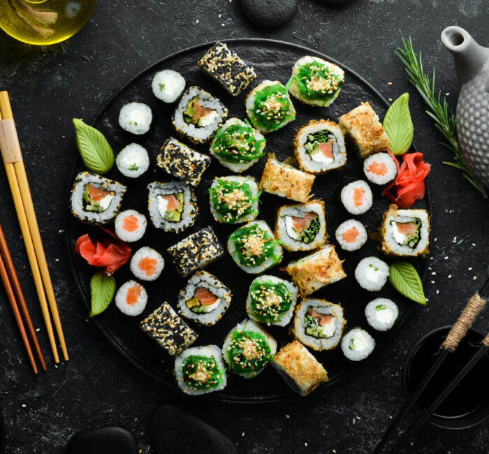 set-traditional-sushi-black-plate-sushi-rolls-dark-background-scaled (1)