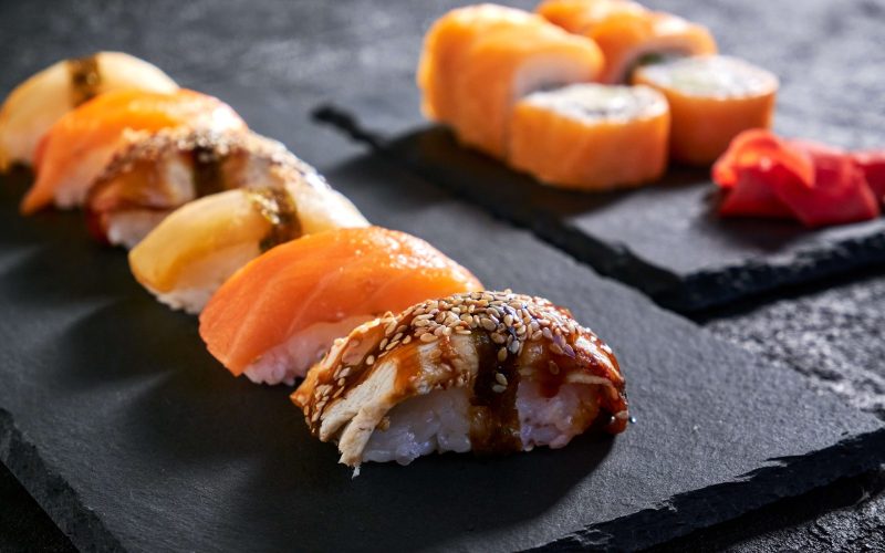 assorted-sushi-with-salmon-eel-escolar-black-stone-plate-dark-background